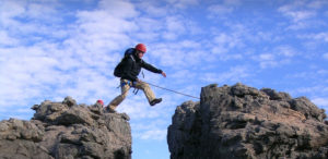 Man jumping over rocks